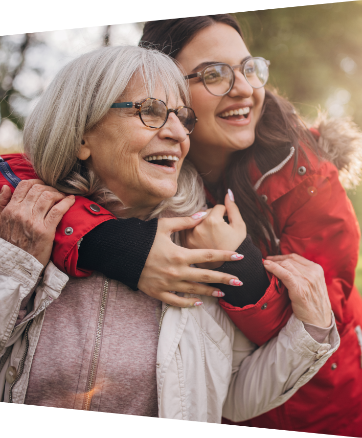 a younger woman embracing an elderly woman